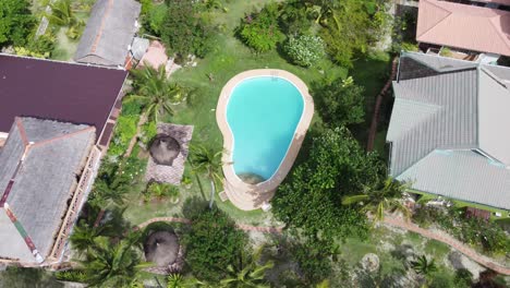 Tropical-beach-villa-with-garden-swimming-pool.-Aerial