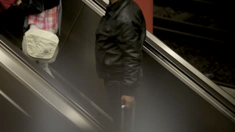 People-ascending-on-an-escalator-in-Stuttgart-station,-angled-view-with-focus-on-moving-steps