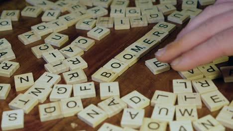 Words-BOOMERS-and-GENZ-are-made-with-Scrabble-letter-tiles-on-table