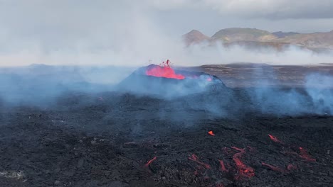 Volcanic-eruption-of-red-lava-from-black-lava-bed