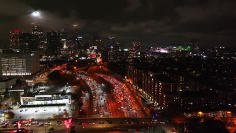 Panoramic-drone-view-of-Downtown-Atlanta-cityscape,-skyscrapers-at-night-under-the-cloudy-sky,-Georgia,-USA