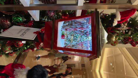 Vertical-View-of-Lamp-shaped-Snow-Globe-Decoration-Inside-The-Building-During-Christmas-Season