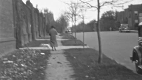 Woman-Walks-Her-Dog-in-the-Grass-in-a-Residential-Area-in-1930s