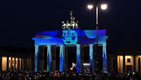 Turistas-En-Pariser-Platz-Viendo-El-Espectáculo-De-Videomapping-En-3D-En-La-Puerta-De-Brandenburgo-En-Berlín,-Alemania