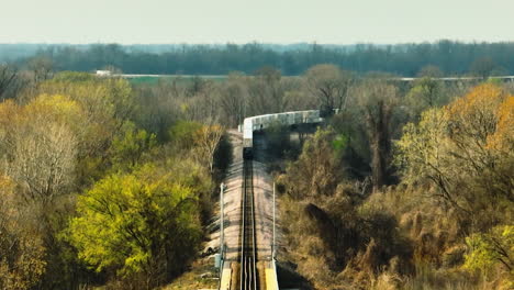 Train-crossing-a-bridge-at-West-Memphis-Delta-Regional-River-Park,-Tennessee,-in-bright-daylight