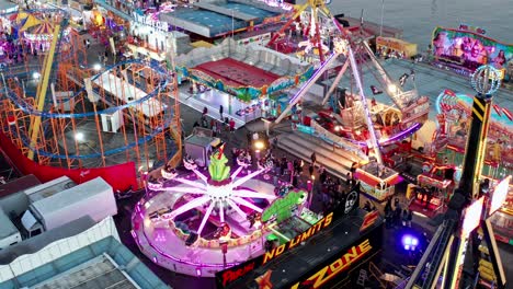 Exciting-illuminated-carnival-rides-in-late-afternoon-at-Genoa-Winter-Park