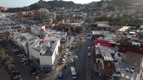 Cabo-San-Lucas-Mexico-downtown-streets-of-cars,-marina-in-background,-aerial-view