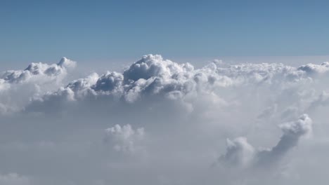 pov-shot-plane-flying-with-big-clouds-and-some-small-clouds-looking-like-fog