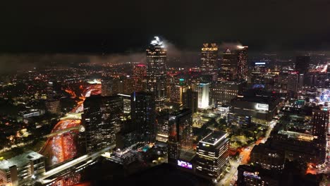 Aerial-view-of-Downtown-Atlanta-cityscape-at-night-under-cloudy-sky,-Georgia,-USA