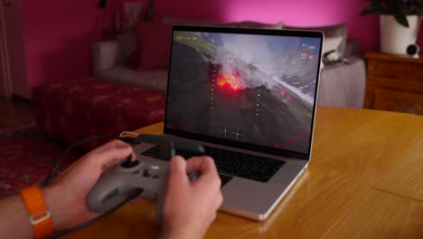 Gamer-plays-a-flight-simulation-video-game-on-a-laptop-using-a-FPV-drone-controller