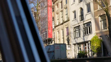 View-from-the-window-of-canal-tour-boat-in-Amsterdam-looking-up-at-art-museum