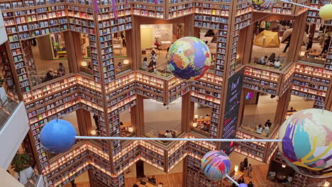 Bookshelf-Walls-Library-Interior-of-Starfield-Suwon-Hall-With-People-Shopping-Walking-on-Different-Floors---high-angle-realtime