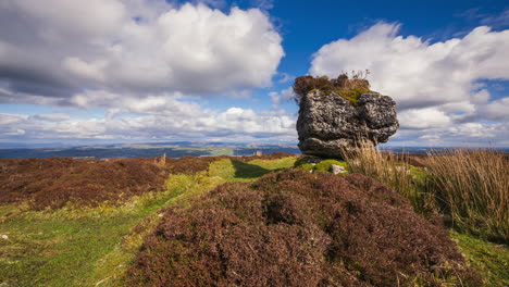 Timelapse-of-rural-nature-bogland-with-ancient-rock-boulder-in-the-foreground-during-sunny-cloudy-day-viewed-from-Carrowkeel-in-county-Sligo-in-Ireland