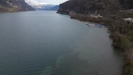 Bird's-eye-view-pan-across-shallow-lake-to-drop-off-in-Walensee-Switzerland