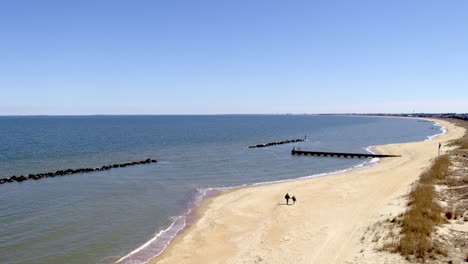 Drone-flying-over-the-beach-in-Oceanview-Norfolk-Virginia,-towards-the-water-in-Northeast-direction