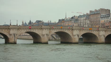 Historic-Pont-Neuf-bridge-over-the-Seine-river-on-a-cloudy-day-in-Paris