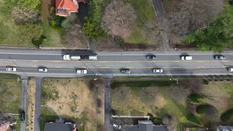 Truck-and-Cars-on-road-in-american-suburb-neighborhood-during-sunny-day-in-spring