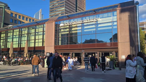 People-Going-Walking-In-and-Out-of-Oslo-Central-Station-on-Sunny-Day,-Norway