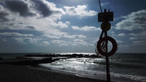 Wide-shot-of-windy-lake-with-lifesaver-on-a-pole-in-the-foreground