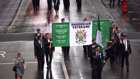 Rhodesian-veterans-walking-down-Adelaide-street-with-crowds-gathered-alongside,-honouring-the-memory-of-those-who-served,-Brisbane-city,-Queensland