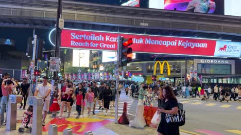 Kuala-Lumpur-Bukit-Bintang-main-intersection-people-crossing-at-night-Malaysia