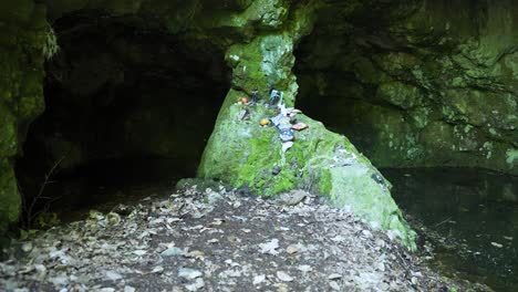 Panning-from-in-front-of-the-entrance-of-an-underground-stream,-in-a-place-known-as-the-tomb-of-the-Egyptian-goddess-Bastet-located-in-Strandzha-Mountain-in-Bulgaria