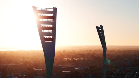 AERIAL-Sun-Shinning-Through-Sporting-Stadium-Light-Towers,-CLOSE-UP