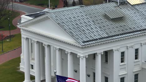 American-and-Virginia-flags-waving-in-front-of-white-columns-of-the-capitol-building-in-downtown-Richmond