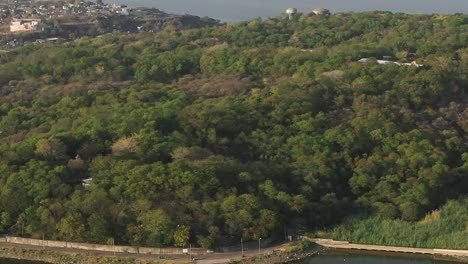 Aerial-drone-view-where-it-looks-like-a-big-mountain-with-a-big-temple-and-lots-of-trees-around