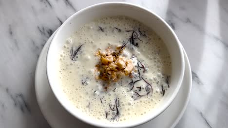 Lisbon’s-Culinary-Heritage:-Traditional-Soup-Served-in-a-White-Plate-on-a-White-Table