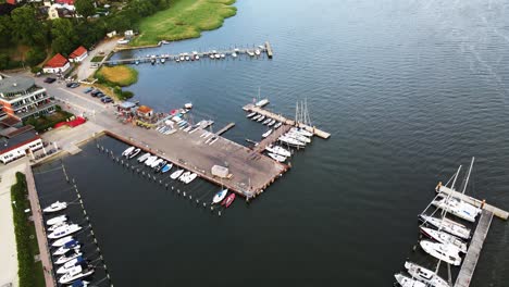 Aerial:-Flying-upwards-a-small-harbour-on-Rügen,-Germany