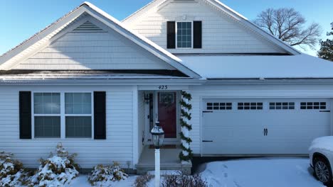 Aerial-flight-towards-white-american-house-with-Christmas-decoration-in-entrance