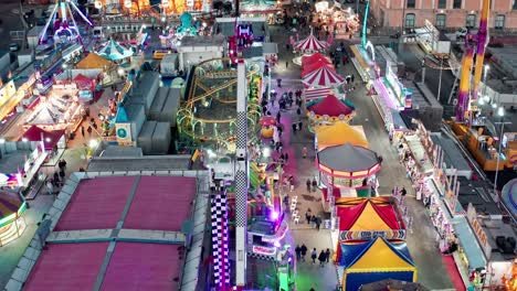 Illuminated-rides-of-Genoa-Winter-Park-on-waterfront,-aerial-view