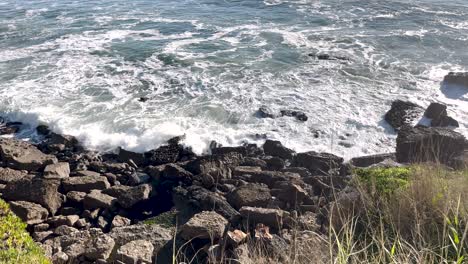 Rocky-cliffs-against-which-waves-crash-in-slow-motion