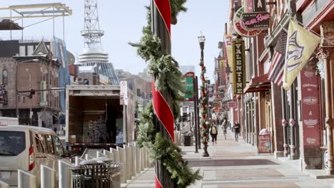 Tourists-on-Broadway-Street-in-Nashville,-Tennessee-during-the-day-with-video-panning-right-to-left