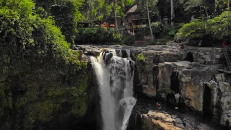 Tegenungan-Waterfall-In-The-Forest-In-Bali,-Indonesia---Drone-pull-back-Shot