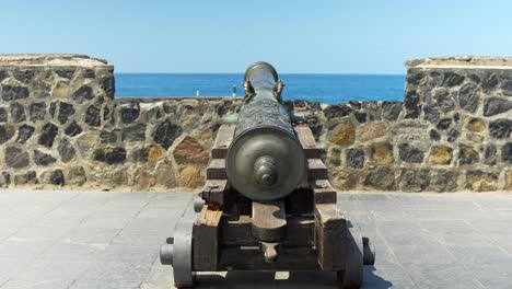 Pan-Up-Historic-Cannon-Defending-Fortress-on-Defensive-Wall,-Tourist-Attraction