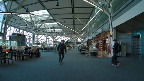 People-in-Airport-Terminal-Food-Court---Wide-Angle,-Slow-Motion