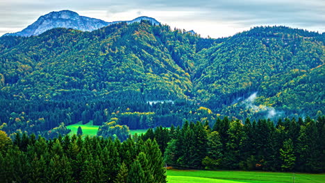 Mountain-range-with-forests-and-morning-mist-timelapse