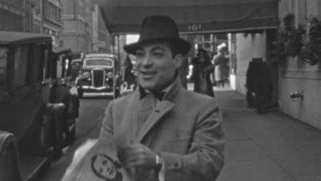 Man-in-Suit-and-Hat-Reads-Newspaper-on-Sidewalk-in-Downtown-New-York-in-1930s