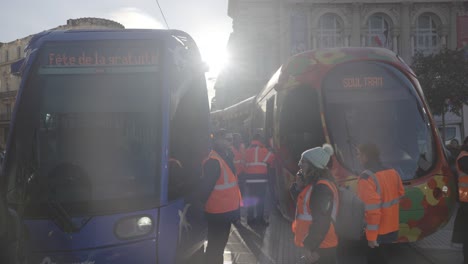 Slow-motion-shot-of-workers-standing-besides-trams-in-downtown-Montpellier