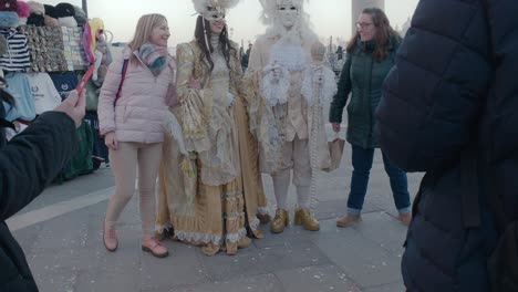 Tourists-Posing-with-Masked-Carnival-Duo,-Venice