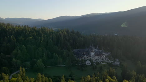 Drone-rotating-around-the-famous-Neo-Renaissance-Peles-castle,-in-high-angle,-super-wide-shot