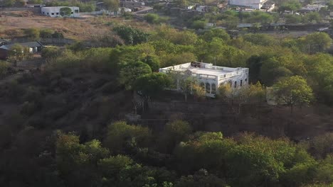 Aerial-drone-view-shows-a-big-palace-surrounded-by-many-big-trees