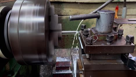 The-lathe-machine-is-cutting-holes-in-iron-rods