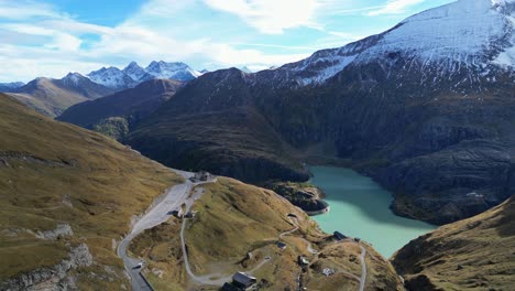 Grossglockner-High-Alpine-Road-and-Blue-Mountain-Lake-in-Austria-Alps---Aerial-4k