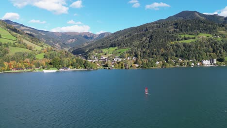 Windsurfer-at-Lake-Zeller-See-during-Summer-in-Zell-am-See,-Austria---4k-Aerial-Circling