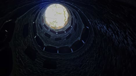 Static-shot-of-vintage-Quinta-da-Regaleira--well-shaft-with-spiral-staircase-in-Portugal