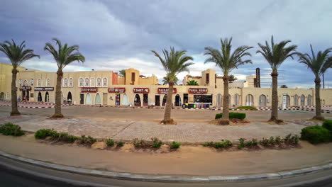 Oriental-architecture-shopping-center-with-palms-and-car-parking-lot