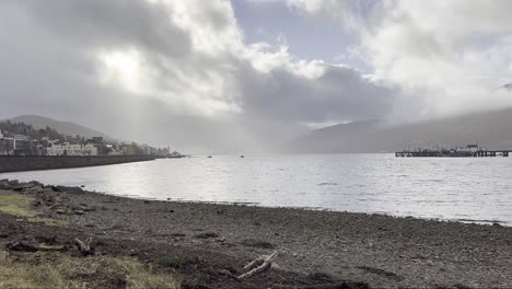 Sun-peaking-through-the-fast-moving-clouds-above-Loch-Eil-in-Fort-William,-Scotland